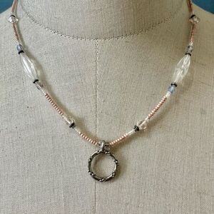 Pink beaded silver tone circle pendant necklace